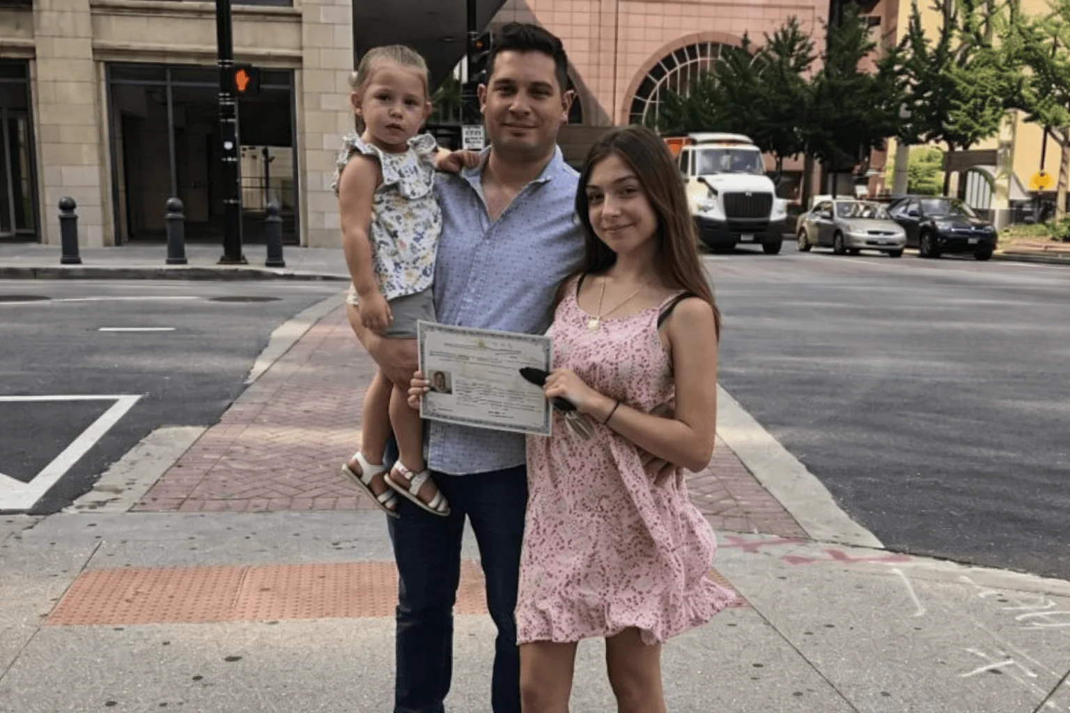 Family holding immigration approval documents after completing the residency or citizenship process.