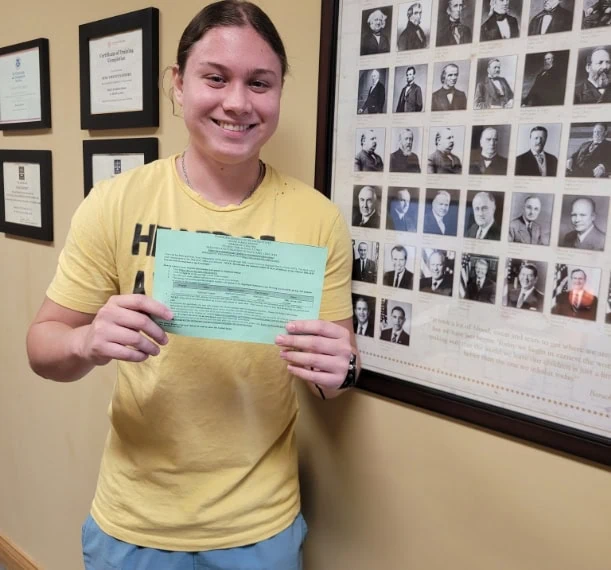 Client holding immigration approval documents starting their immigration journey.